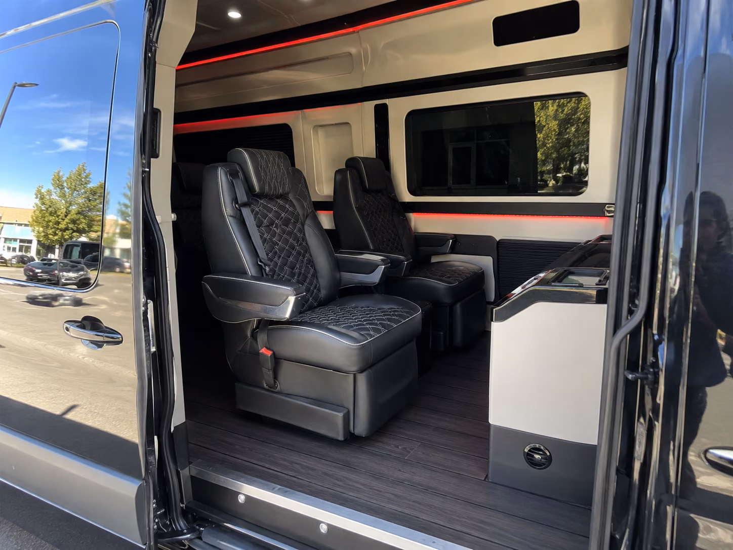 orange sprinter van with driver inside